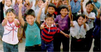 Photo of happy school children in San Juan la Laguna, happy because they have been given 3 pencils each